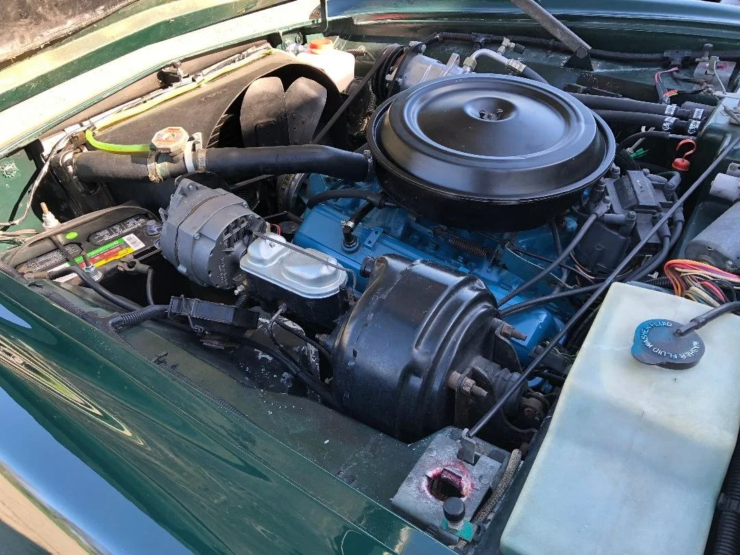 Underhood shot of the 305 V8 4-barrel engine showing original details and 52,761 miles.
