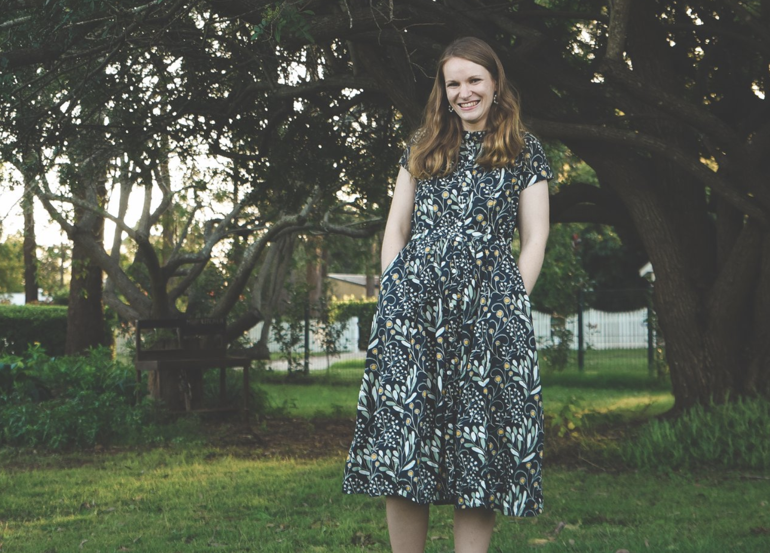 stephanie heartfield play therapist and counsellor in a floral dress smiling with trees in the background