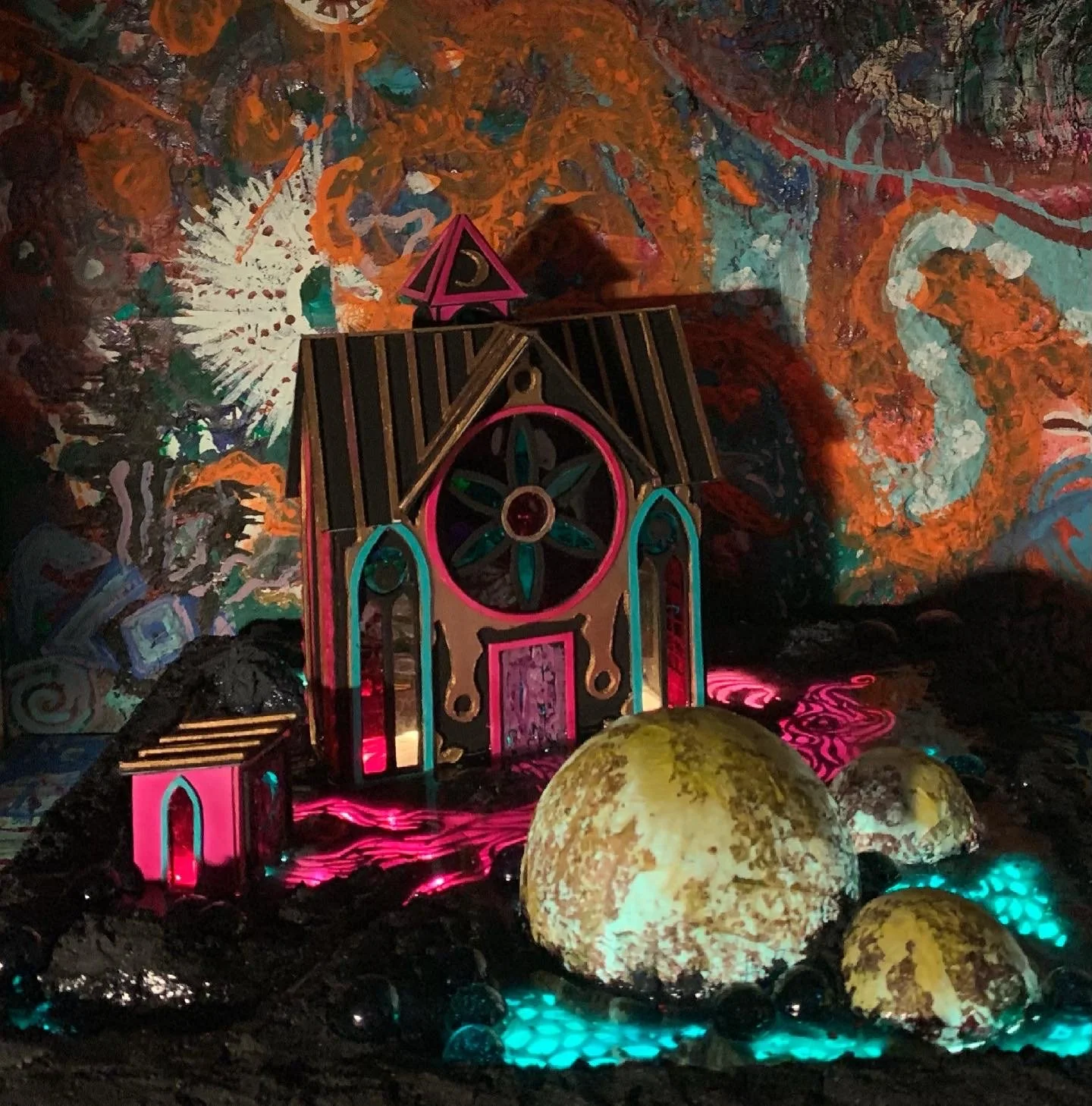 A miniature fantasy scene with a colorful, ornate castle surrounded by glowing orbs and a vibrant, abstract background.