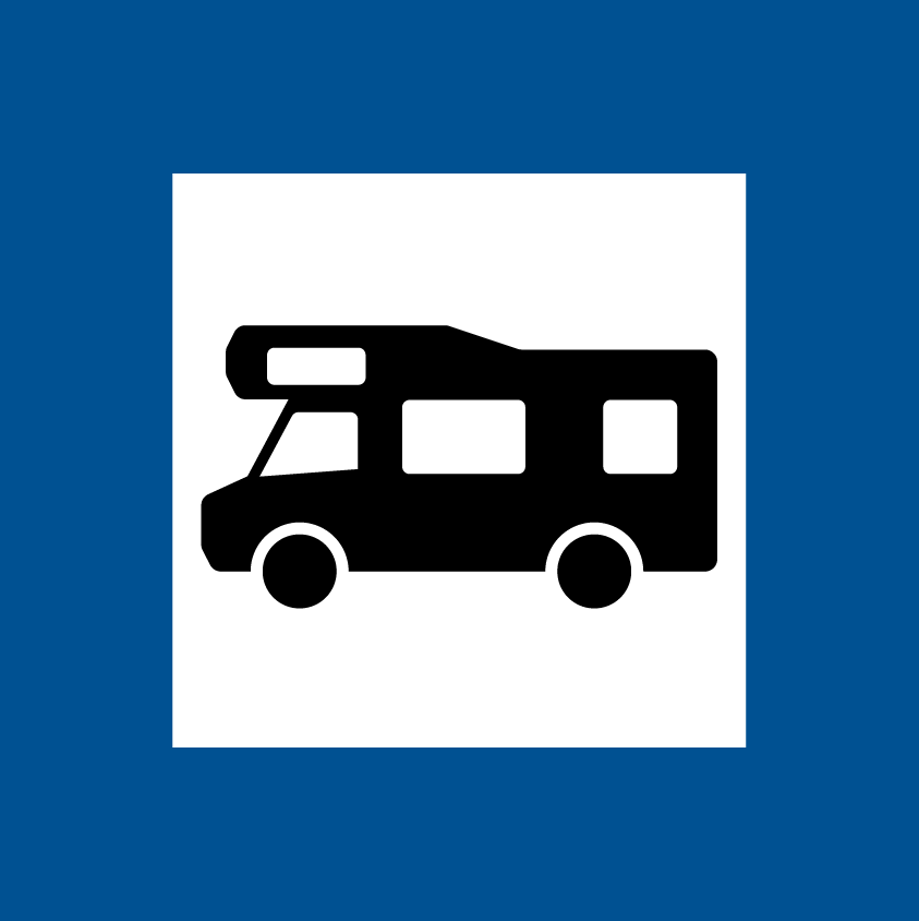 En blå och vit vägskylt som visar en campingbuss.