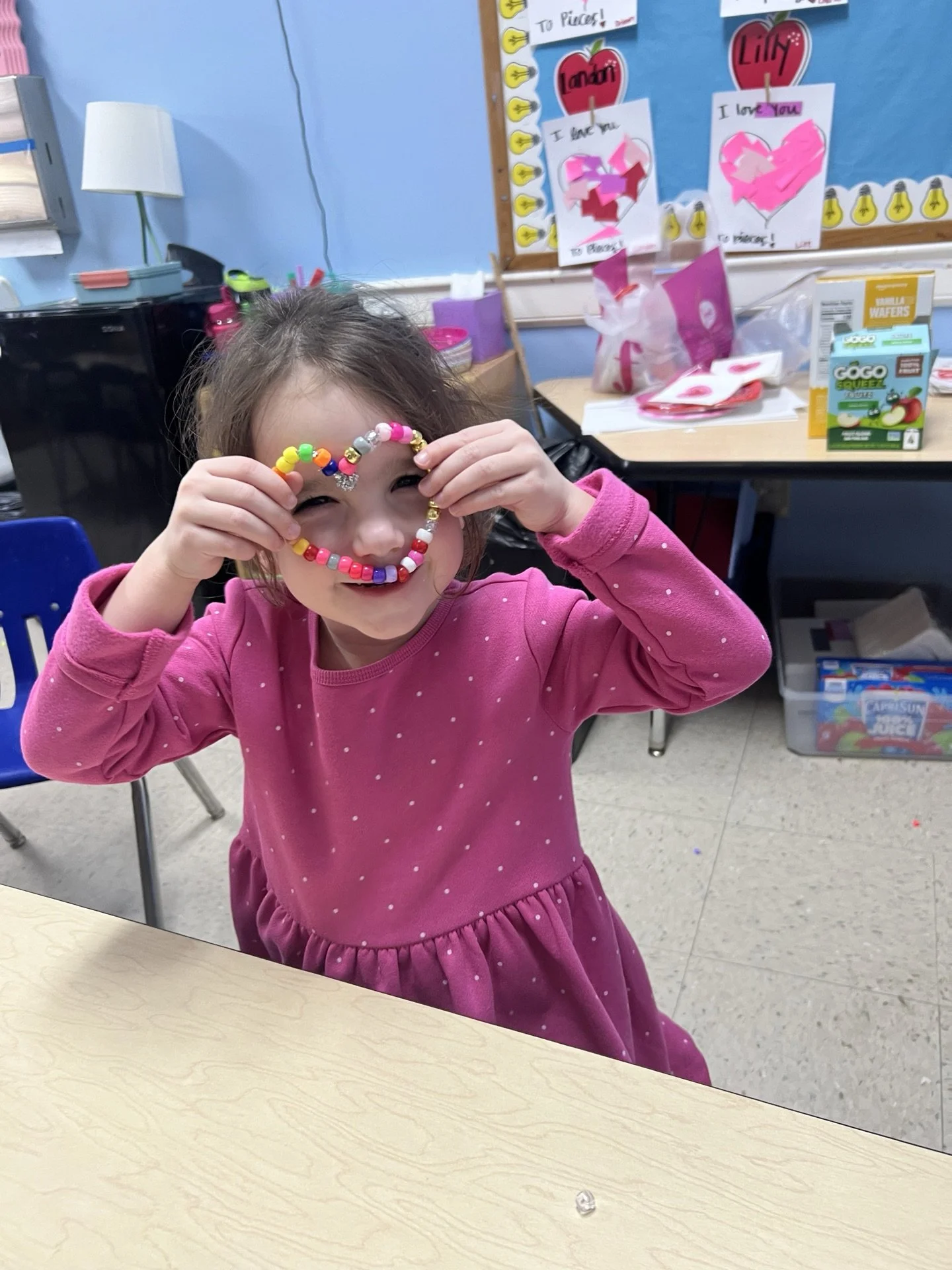 Small child with heart beads