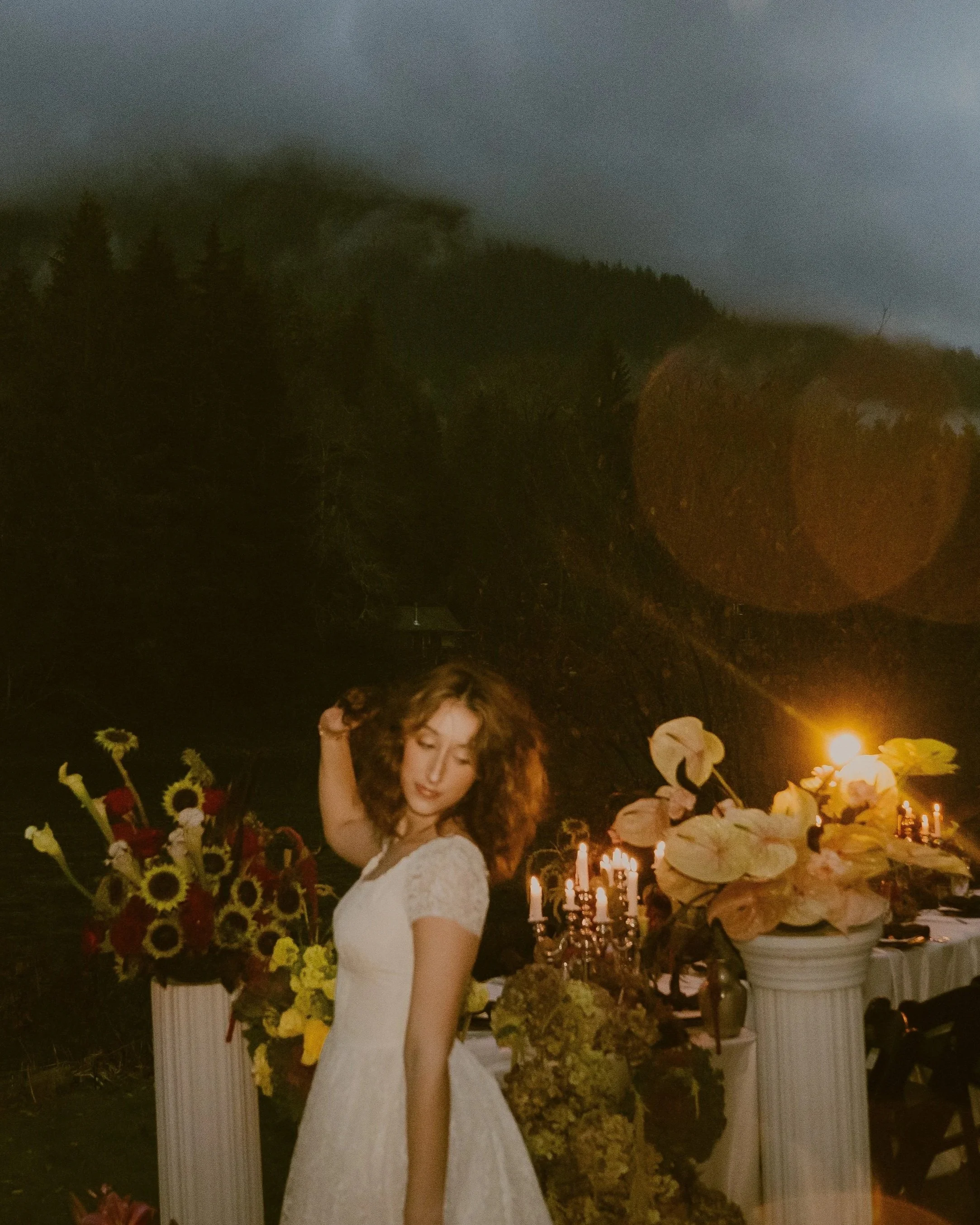 bride poses while looking at the ground and playing with her hair.