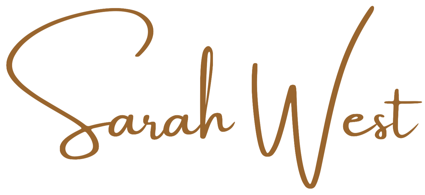 Brown cursive text that reads "Sarah West" with a heart shape incorporated into the "S".