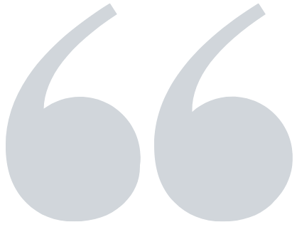 Close-up of a large gray quotation mark symbol.