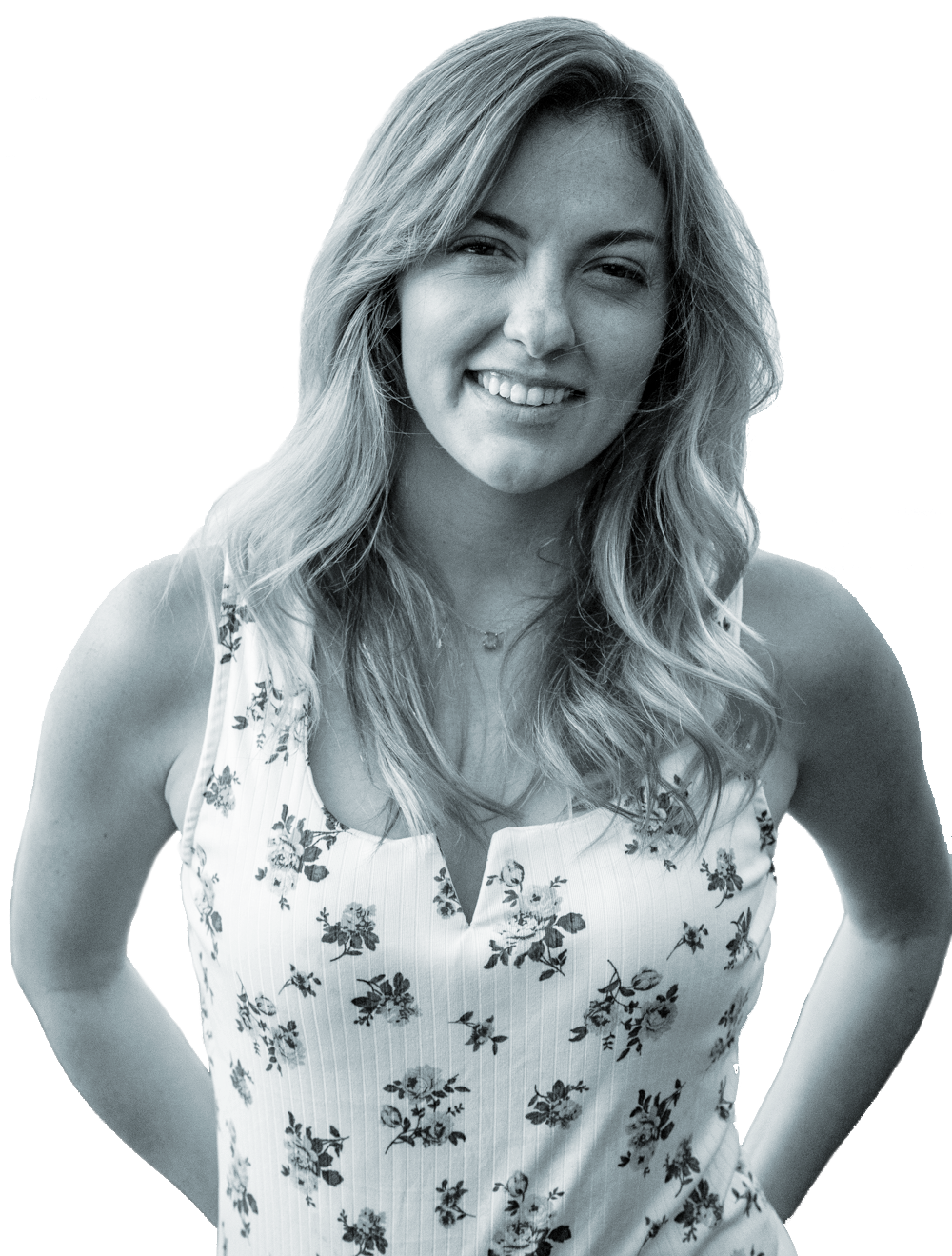 A smiling woman with wavy, shoulder-length hair, wearing a sleeveless floral top and a necklace.