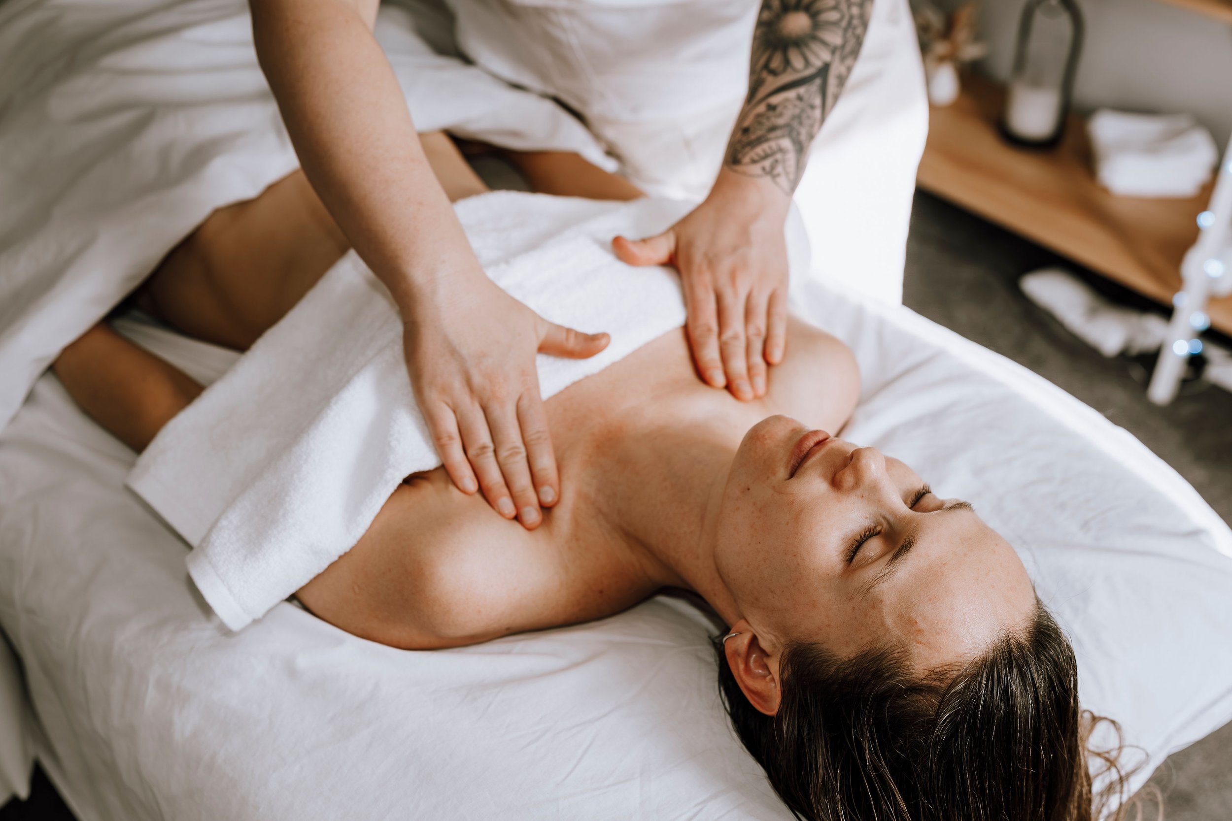 Person receiving a massage on their chest in a massage therapy session.
