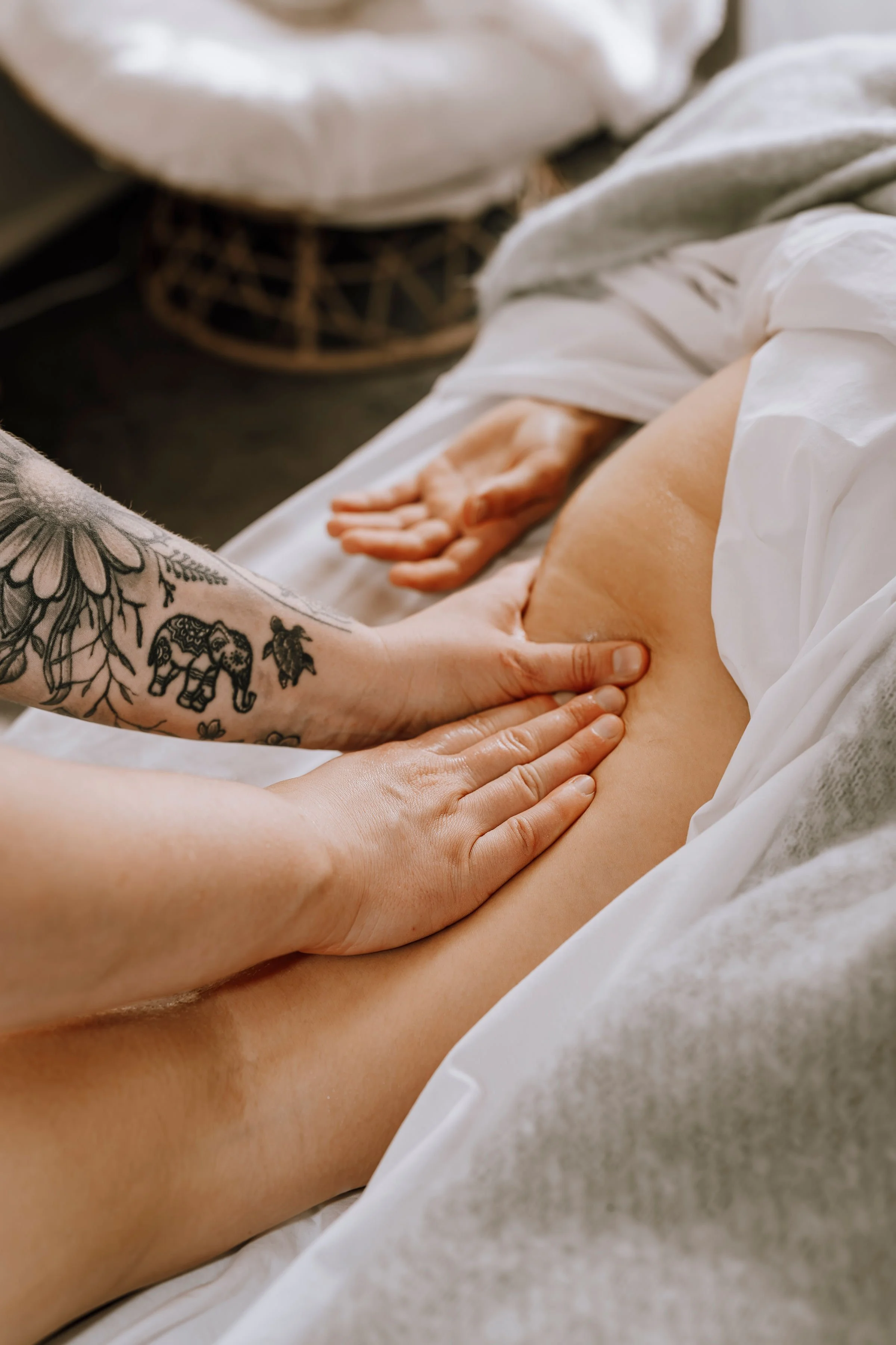 A person getting a massage on their abdomen in a relaxing setting.