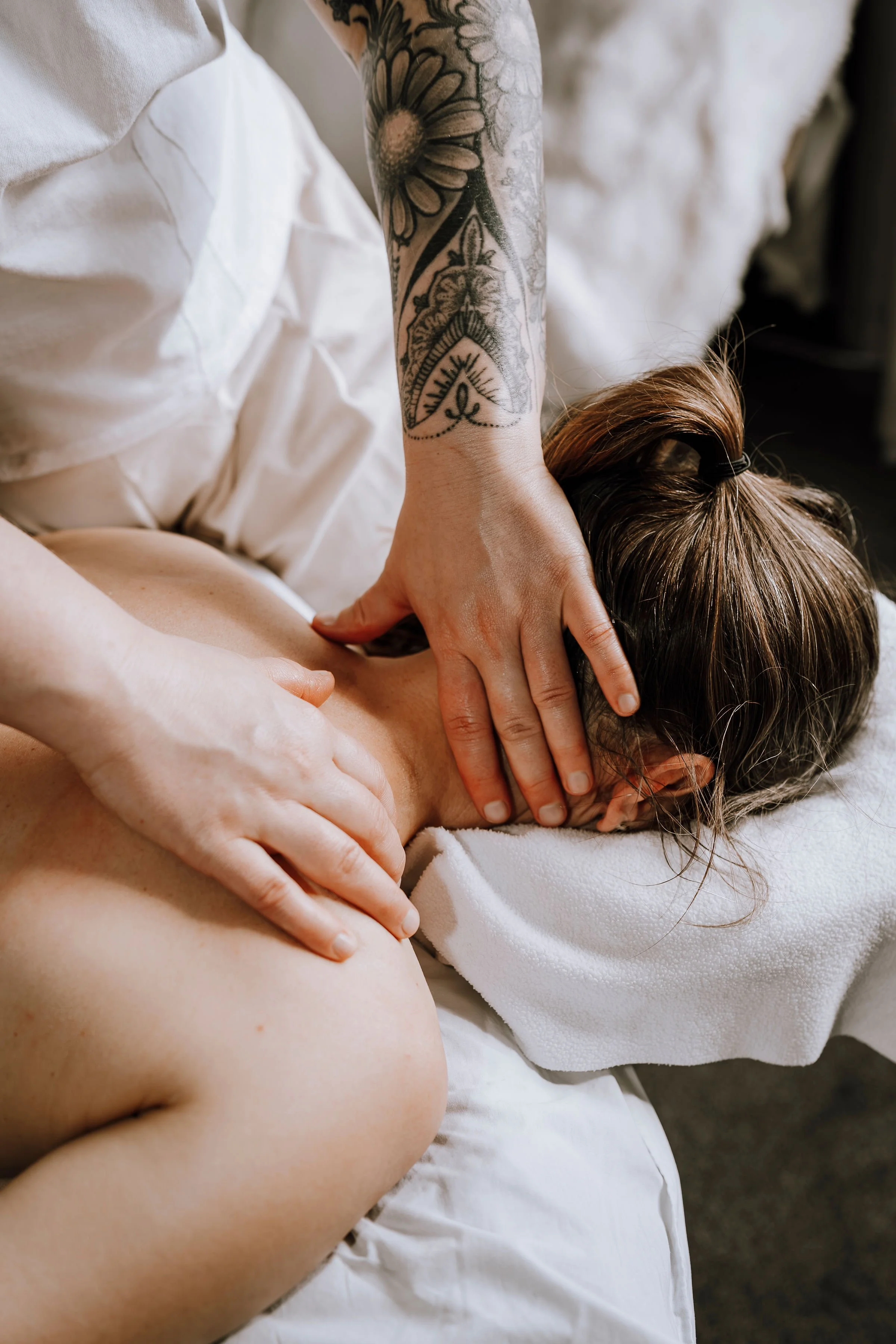 Person receiving a massage or physical therapy on their back with a therapist applying pressure with their hands, close-up view.