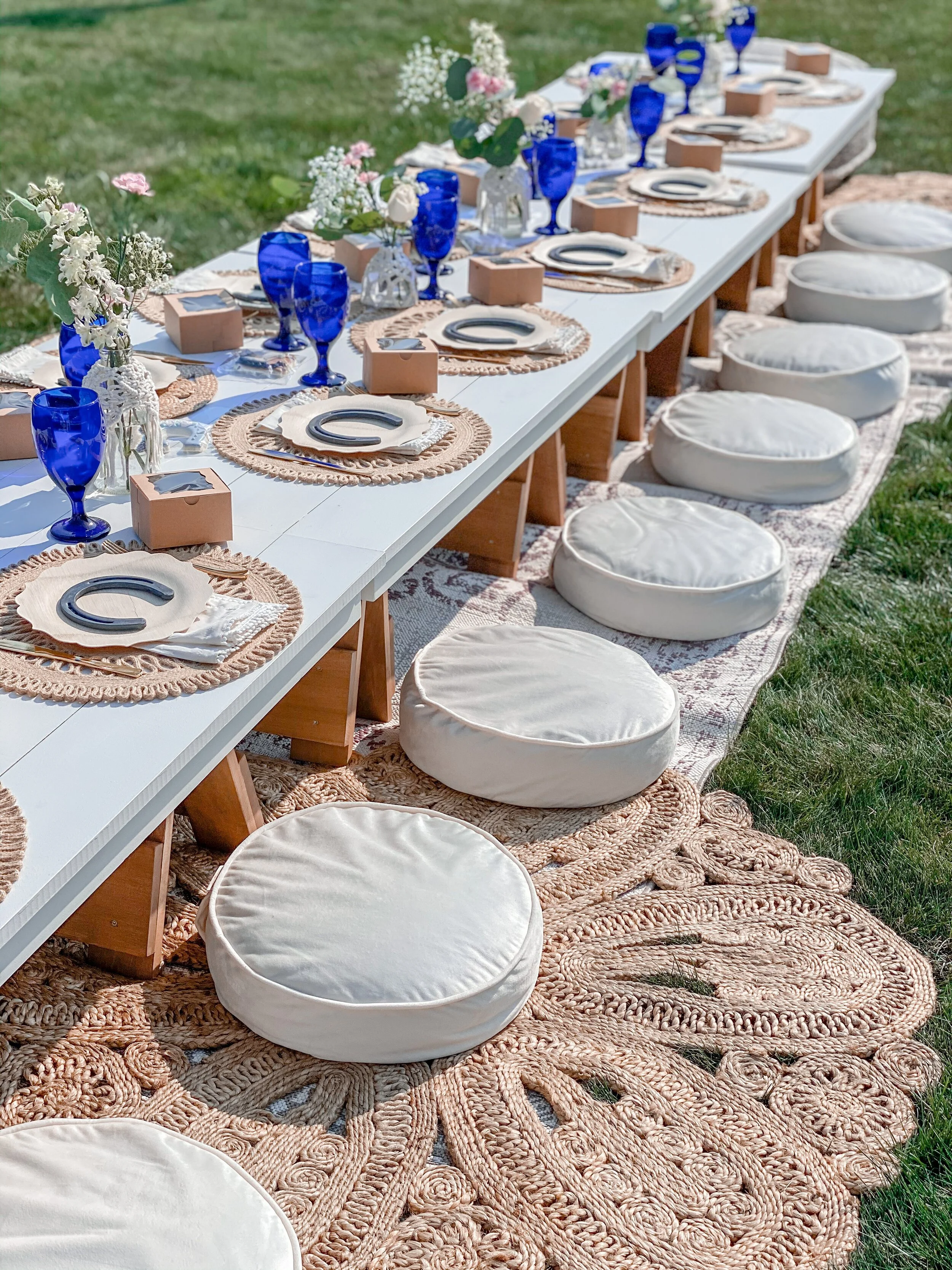 A long handmade Open Table dressed outdoors
