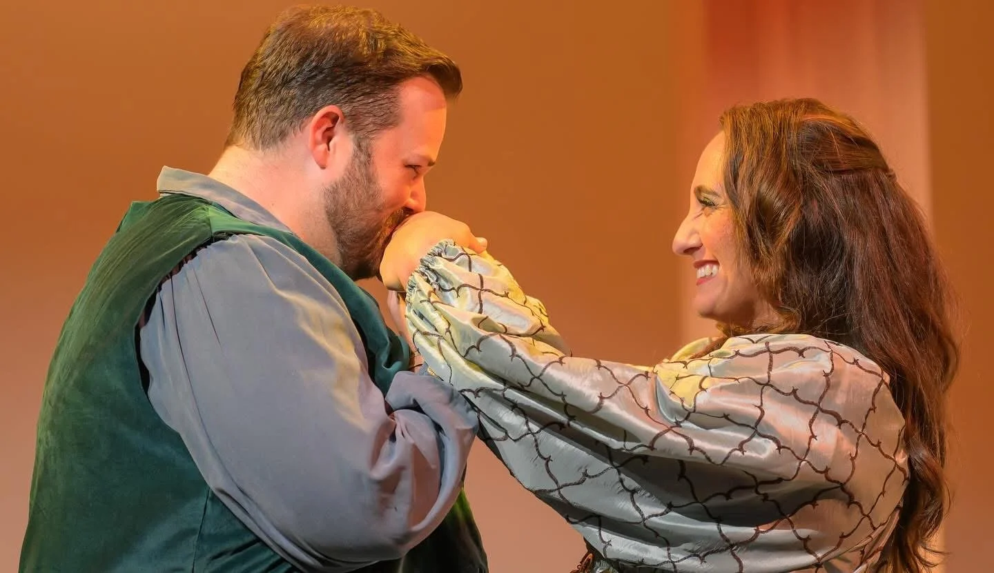 A woman and a man sharing a joyful moment, with the woman gently touching the man's face and both smiling warmly.