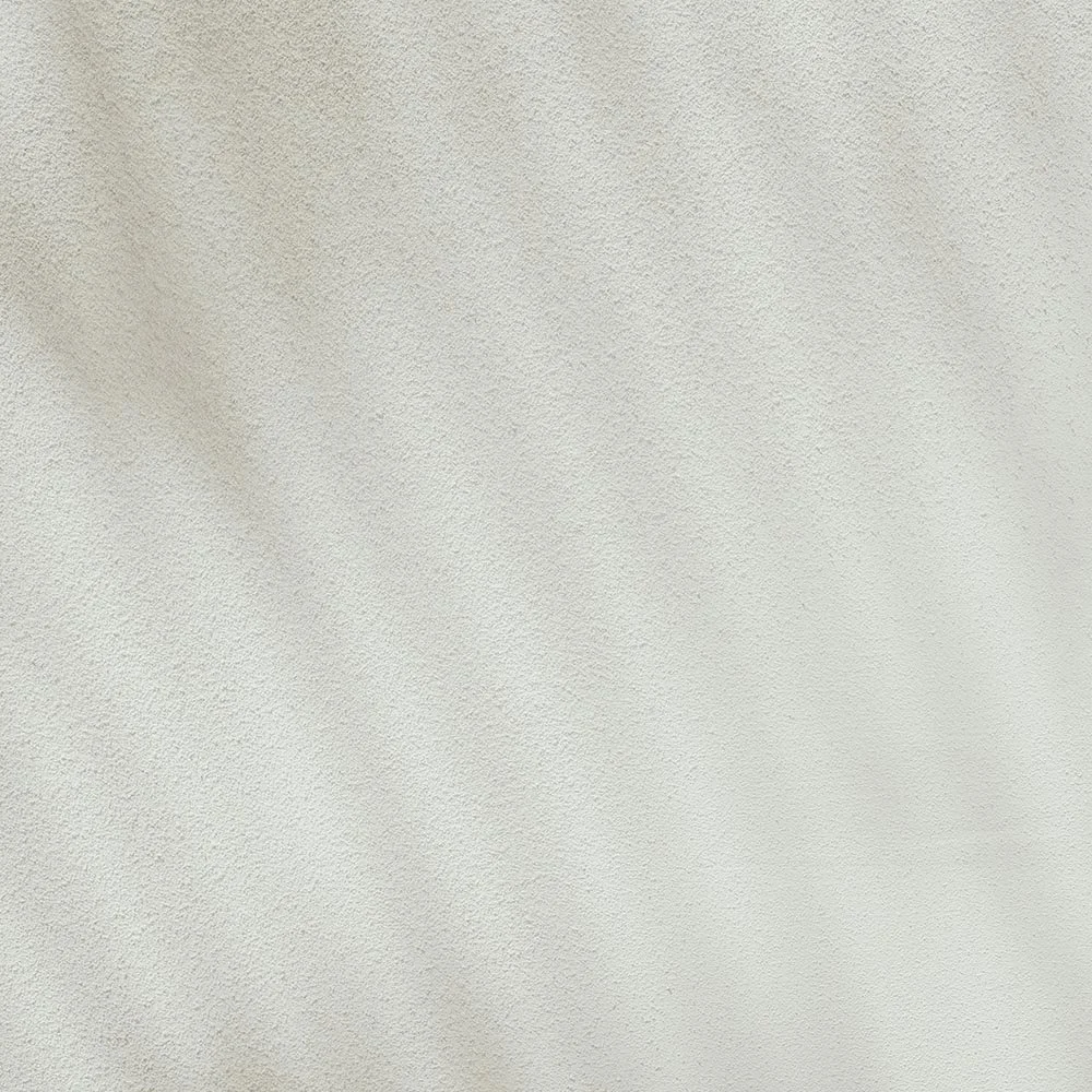 A plain white textured wall.