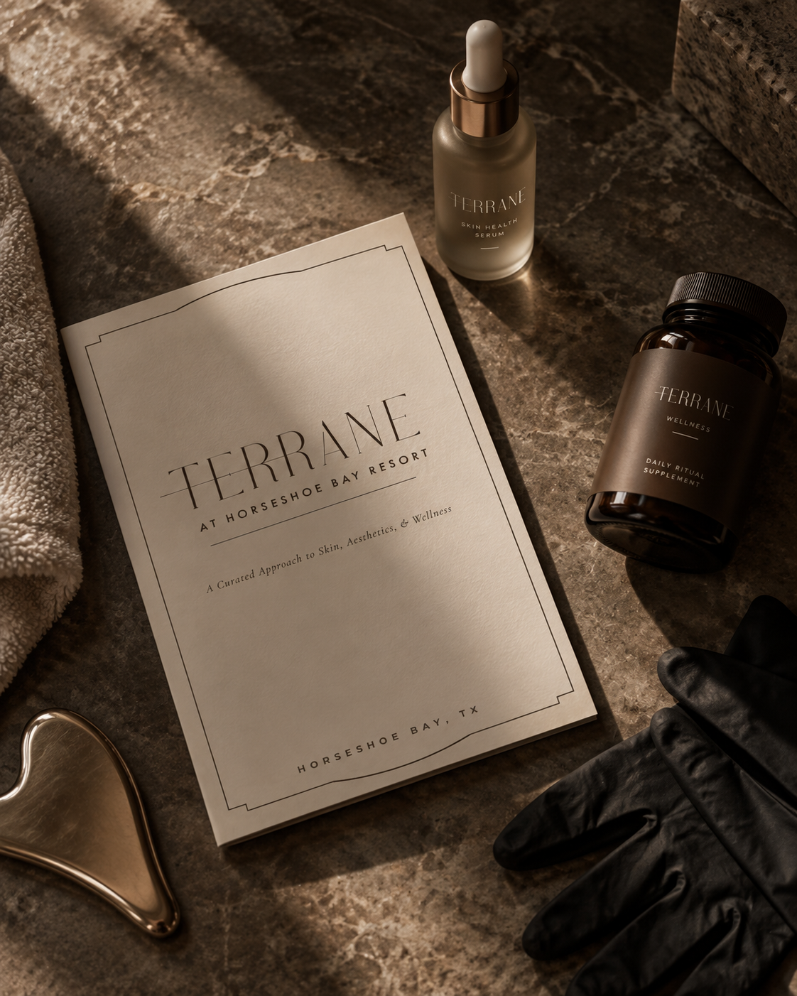 Spa brochure for Terrane at Horseshoe Bay Resort, showing skincare products, a black glove, a towel, and a gold facial roller on a marble surface.
