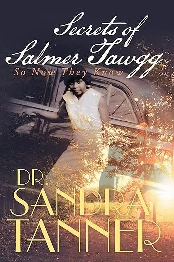 A book cover with the title Secrets of Salmer Tawgg. Colors are black with a grey car superimposed and a young black girl standing in front of the car. A superimposed tree can be seen beside her. By Dr. Sandra Tanner