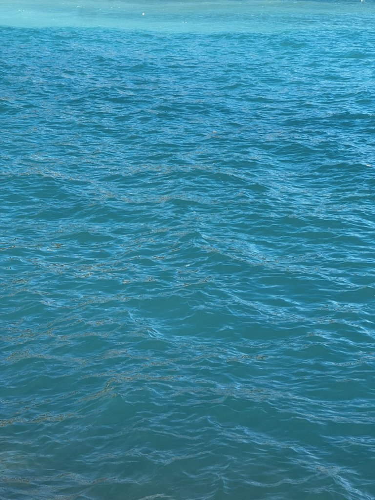 Expansive view of blue ocean water with gentle waves and ripples.