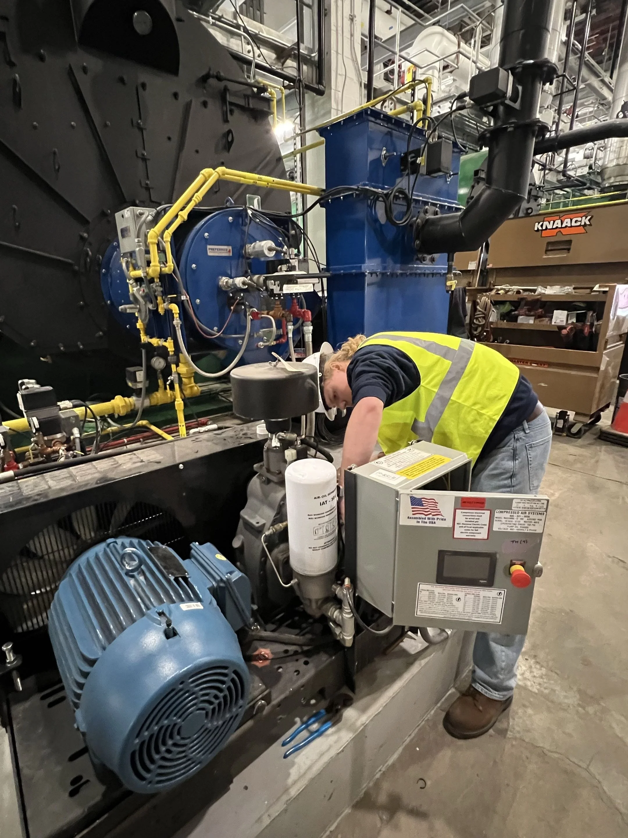 Alec chases a leak on an air compressor at the Bronx Community College which received three new boilers with Preferred burners and instrumentation. 