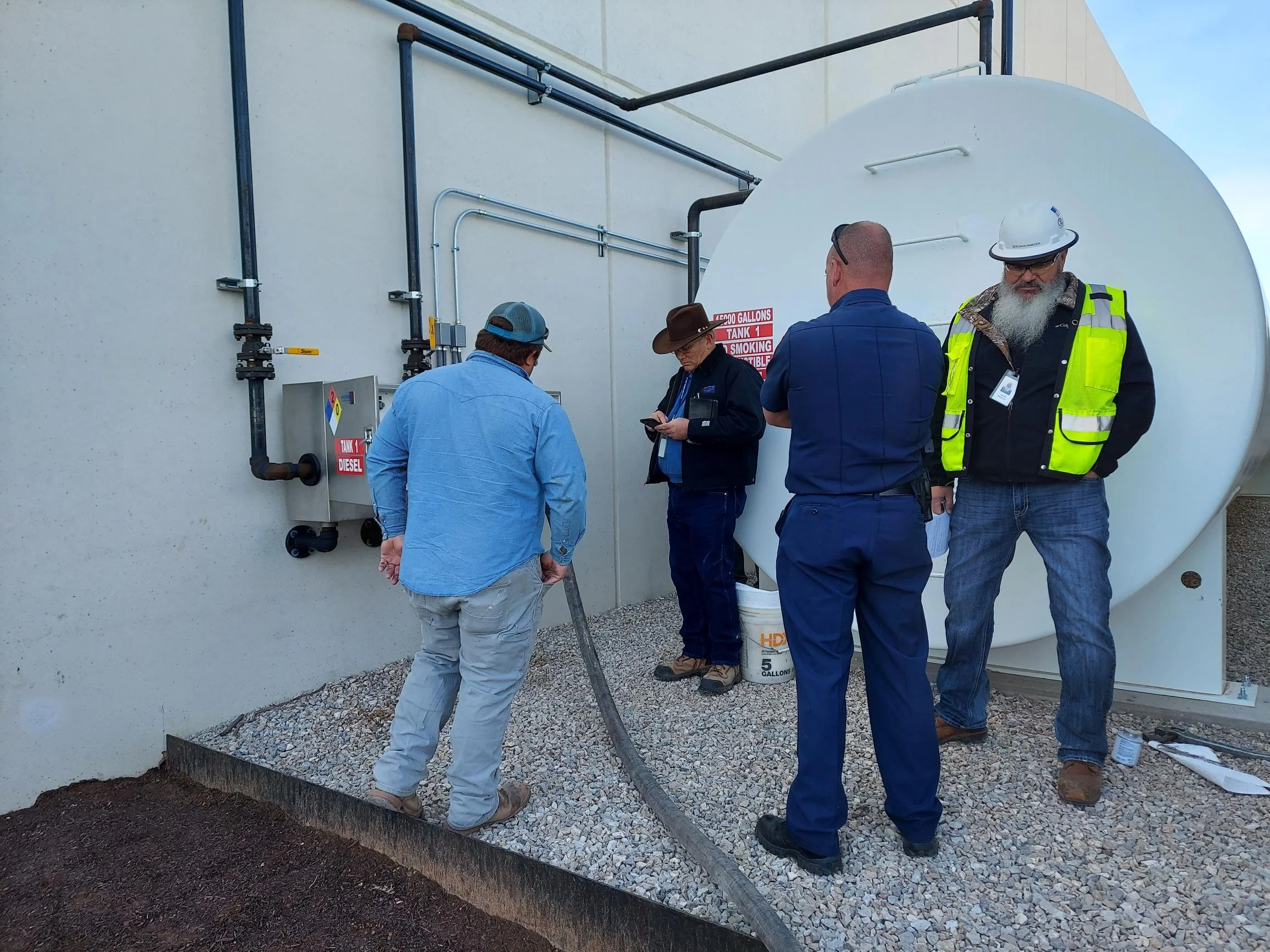 A well-supervised truck driver hooks up his hose to unload his fuel truck into a 20,000 gallon main tank at a data center in north Dallas. The stainless steel Preferred type 2 fill box is shown to the left.