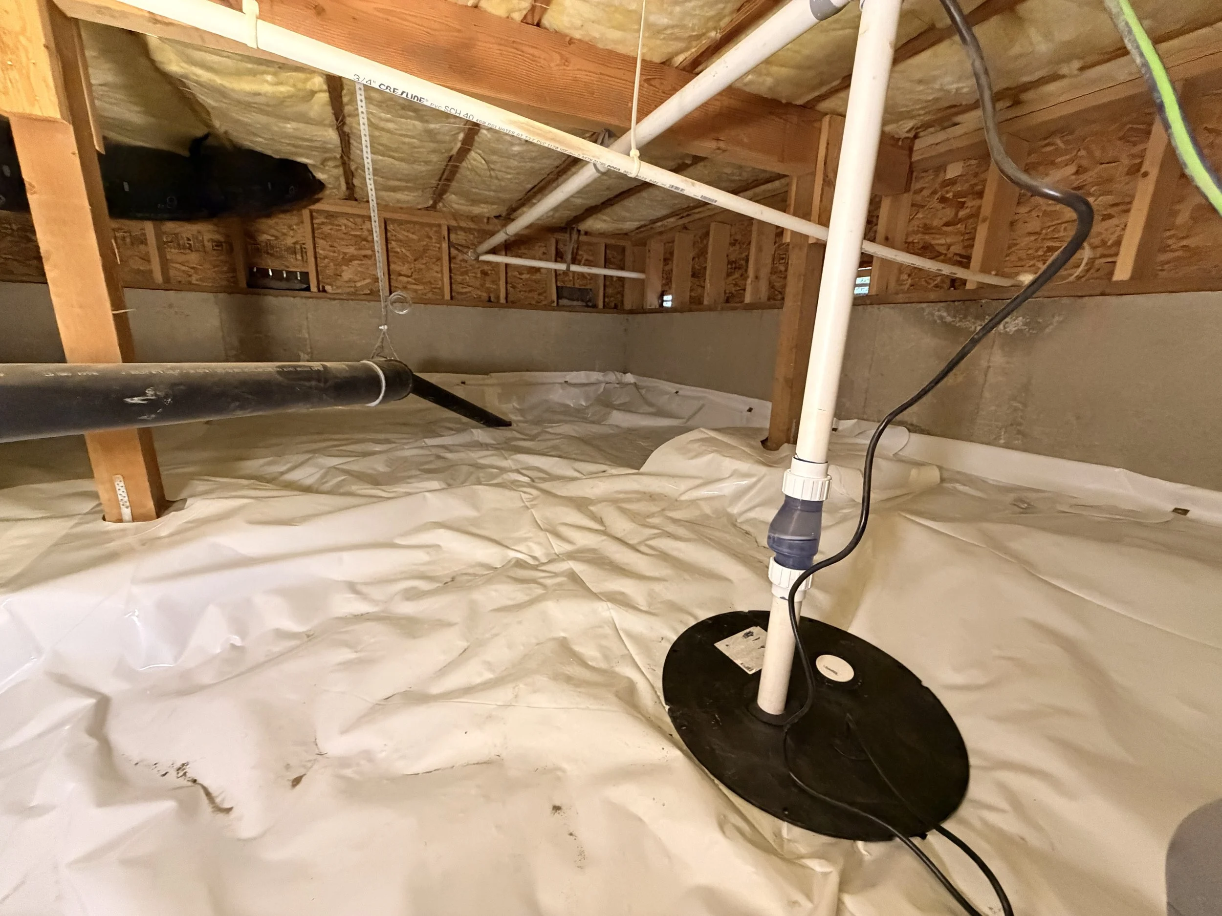 Crawl space sump pump installation with new vapor barrier