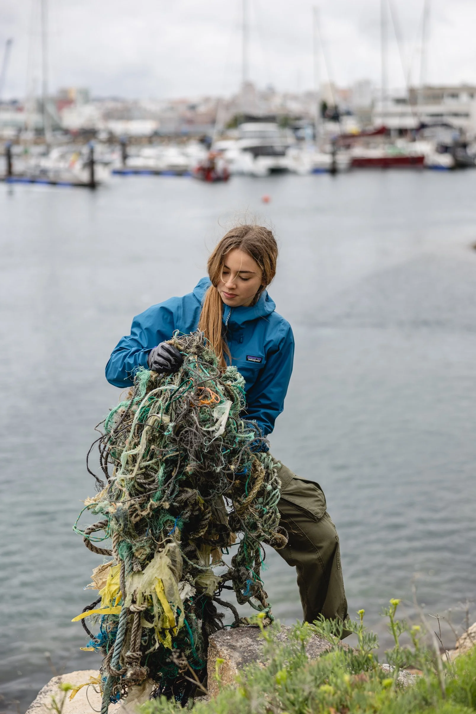 Environmental youth activist Olivia Mandle picking up plastic during a beach cleanup