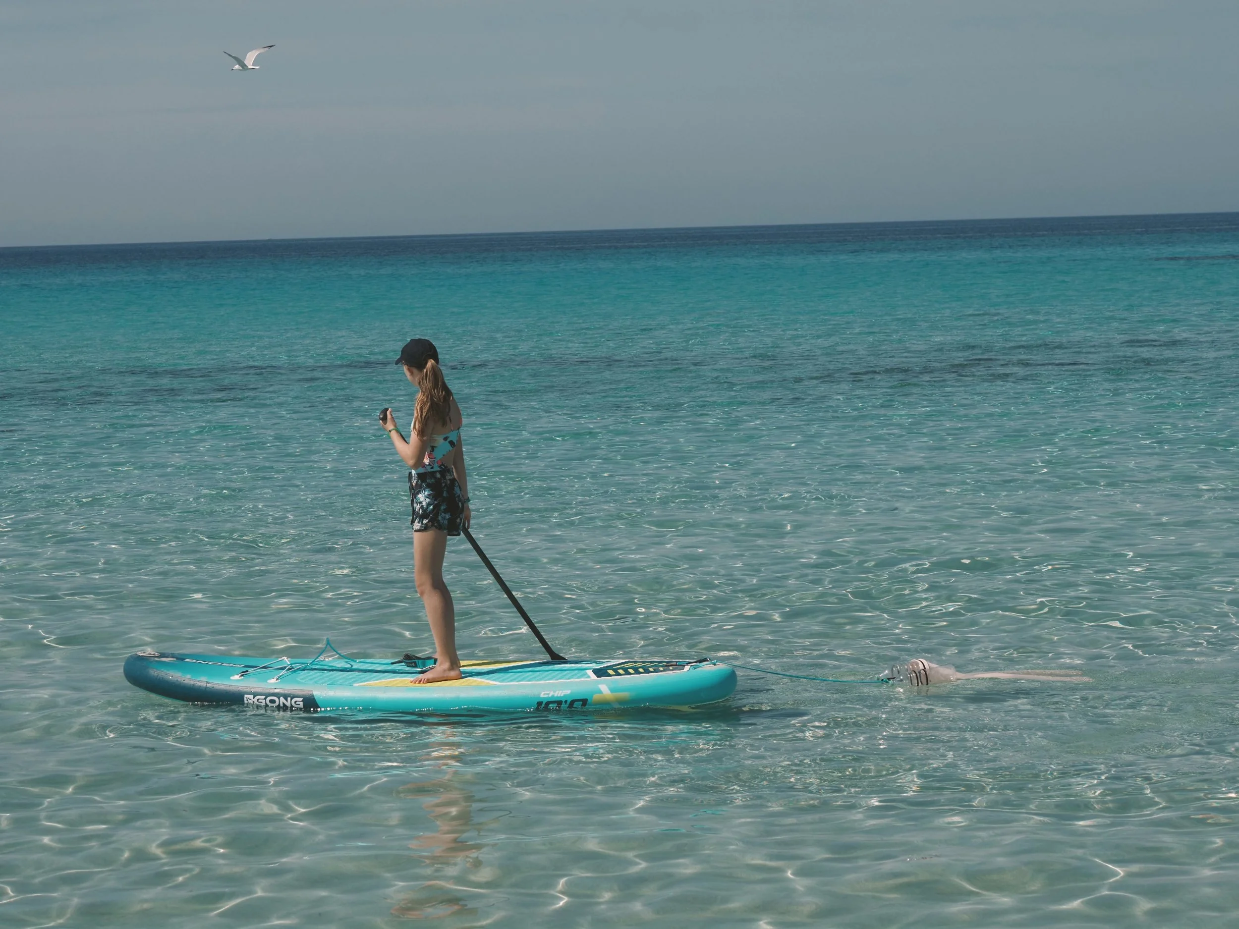 Environmental youth activist Olivia Mandle using her Jelly Cleaner on a stand up paddle board.