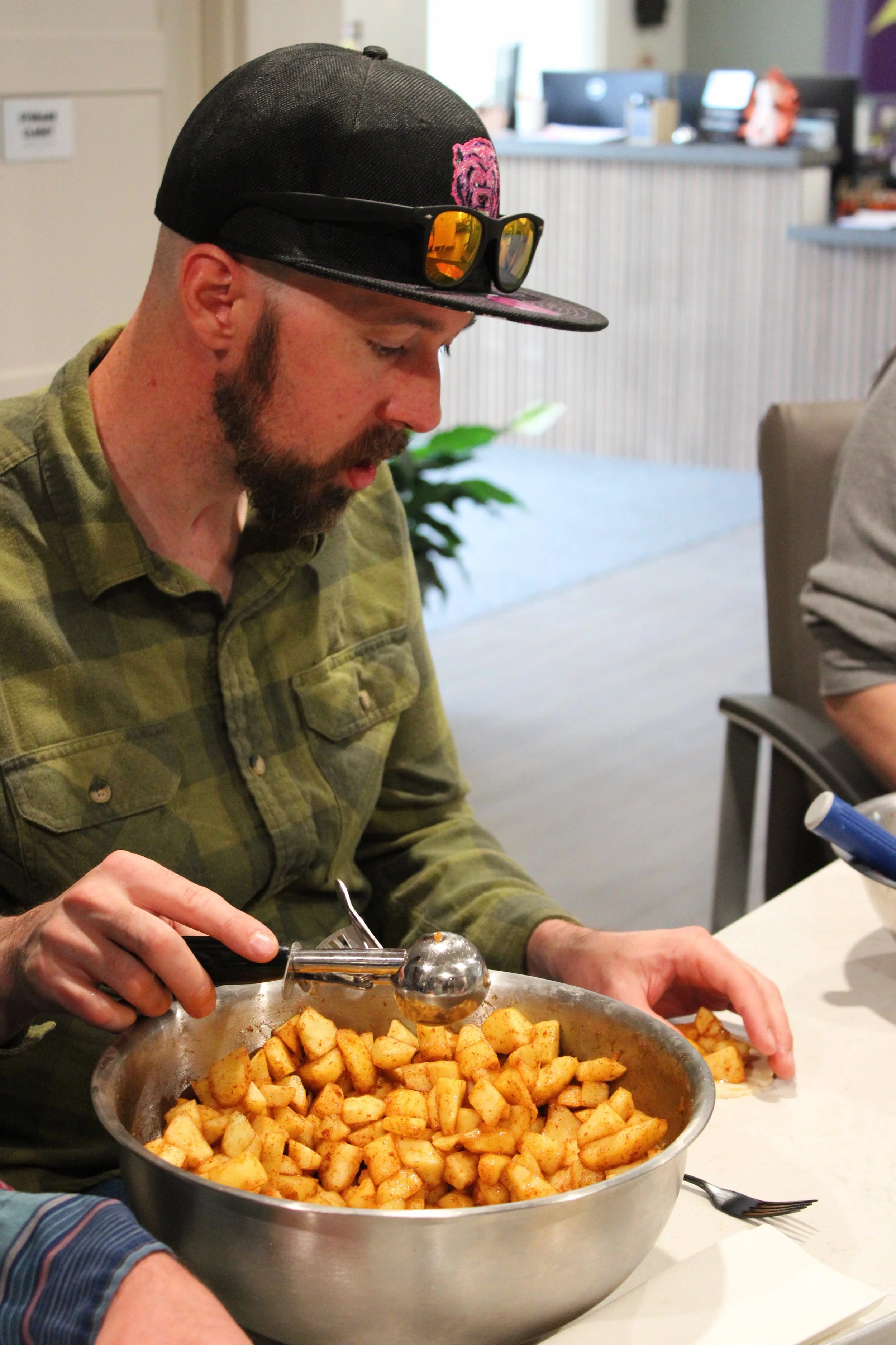 A man with a brain injury in the resident kitchen at 2730 making a pie