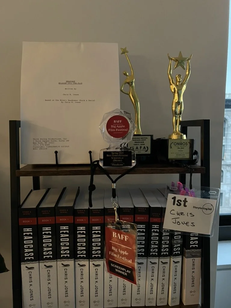 Books titled 'Headcase' by Chris K. Junes on a shelf, with awards and a first-place note from the Big Apple Film Festival, along with trophies and a white paper with typed text.