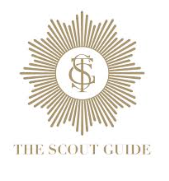 Golden emblem with rays radiating outward, enclosing a monogram of intertwined letters S, C, and G, and text below reading 'The Scout Guide' in gold letters.