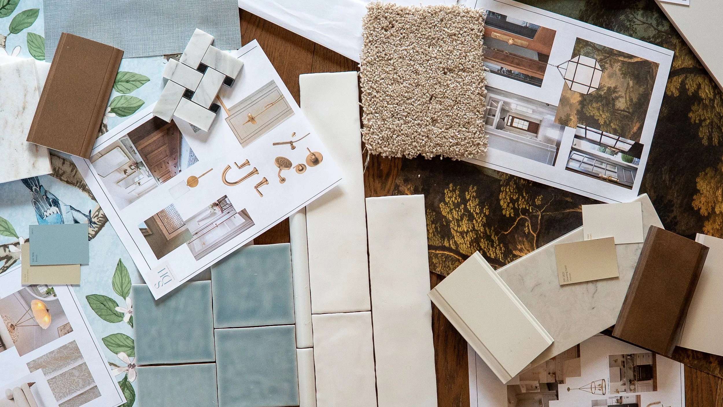 Interior design planning with sample tiles, fabric swatches, paint color swatches, mood boards, and home decor inspiration on a wooden table.