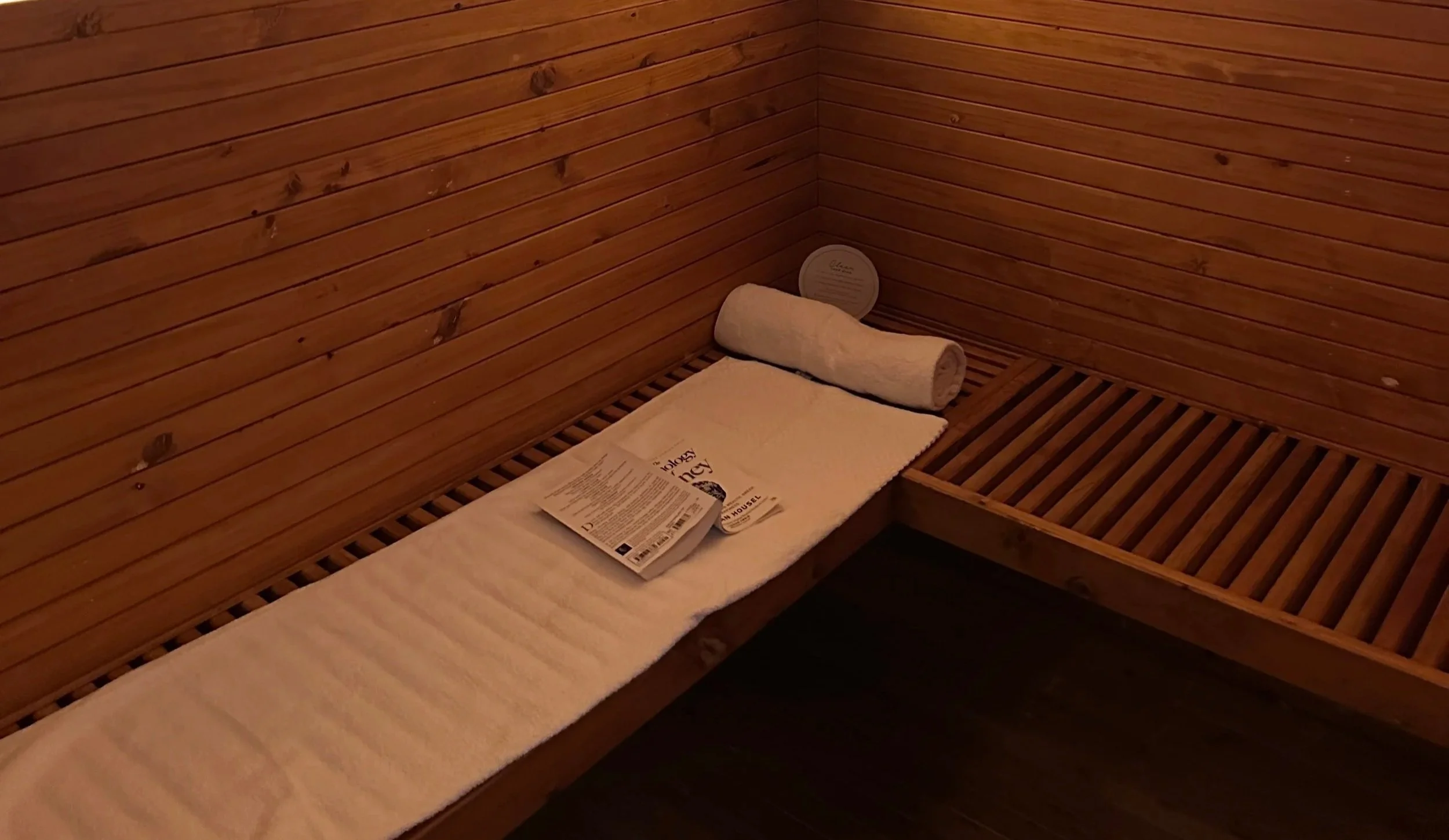towel and book inside an infrared sauna