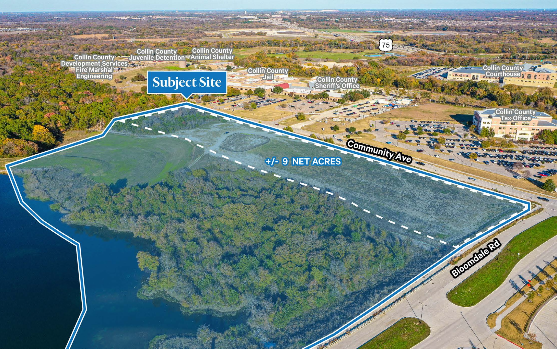 Aerial view of a county facility and surrounding land with labels pointing out various county buildings and sites, including a subject site on a wooded area near a water body, with roads and parking lots visible.