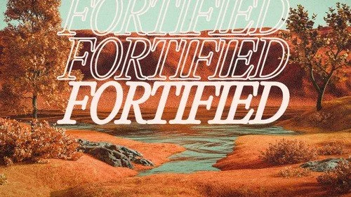 Autumn landscape with a river and trees with orange leaves, with the word 'Fortified' repeated three times in different styles overlaid on top.