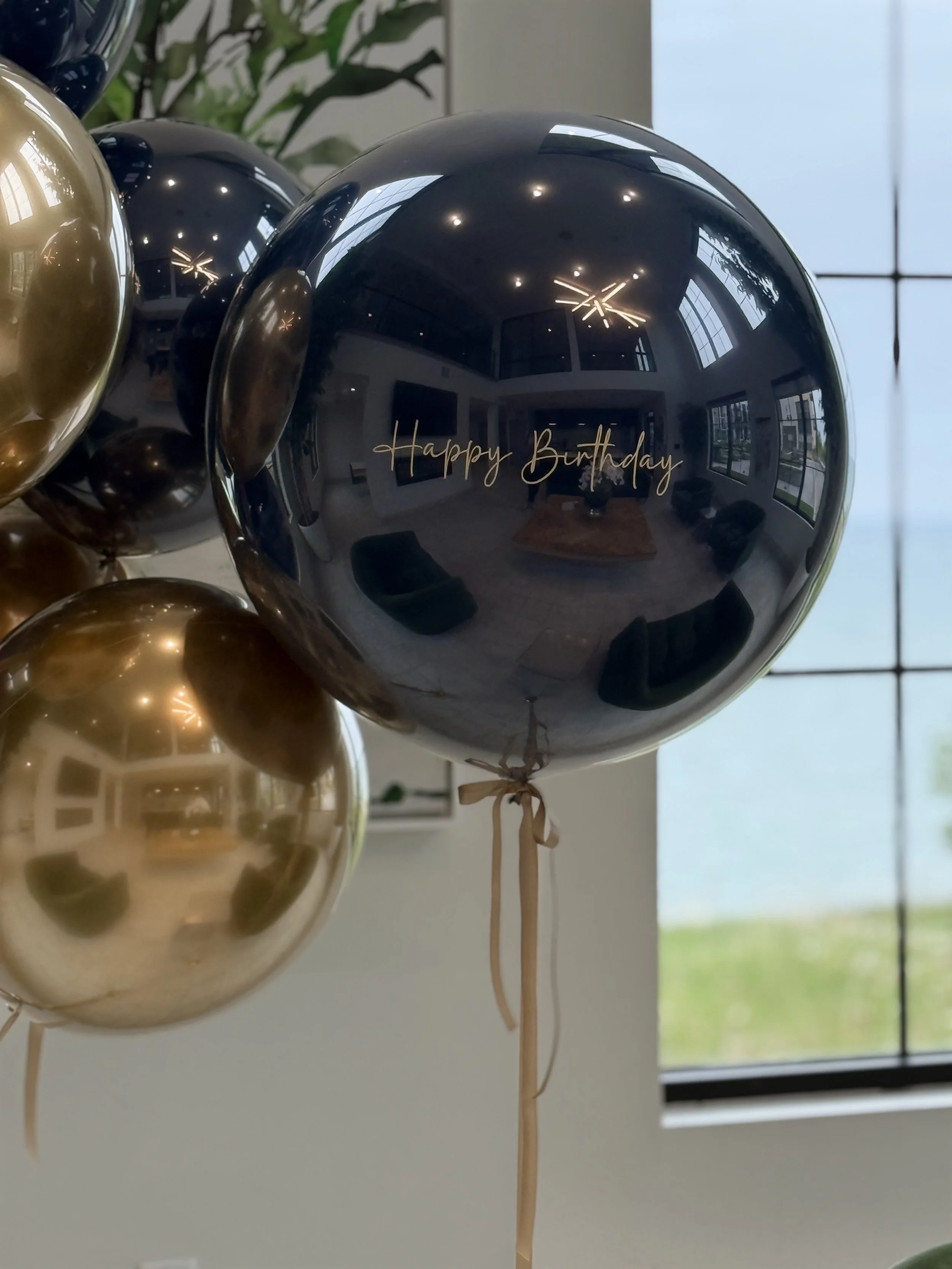 Luxury midnight blue and gold double-stuffed birthday balloon bouquet with oversized 18-inch helium balloons and custom 24-inch balloon with text by House of Balloons Milwaukee