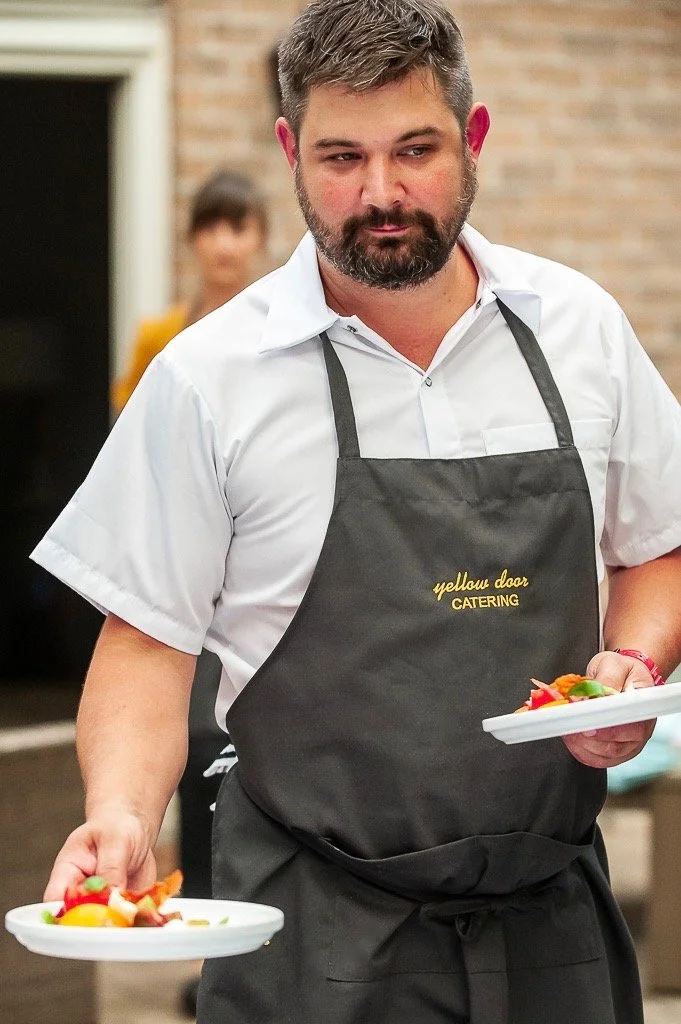 Chef Bill Horodecky serving a plate of food