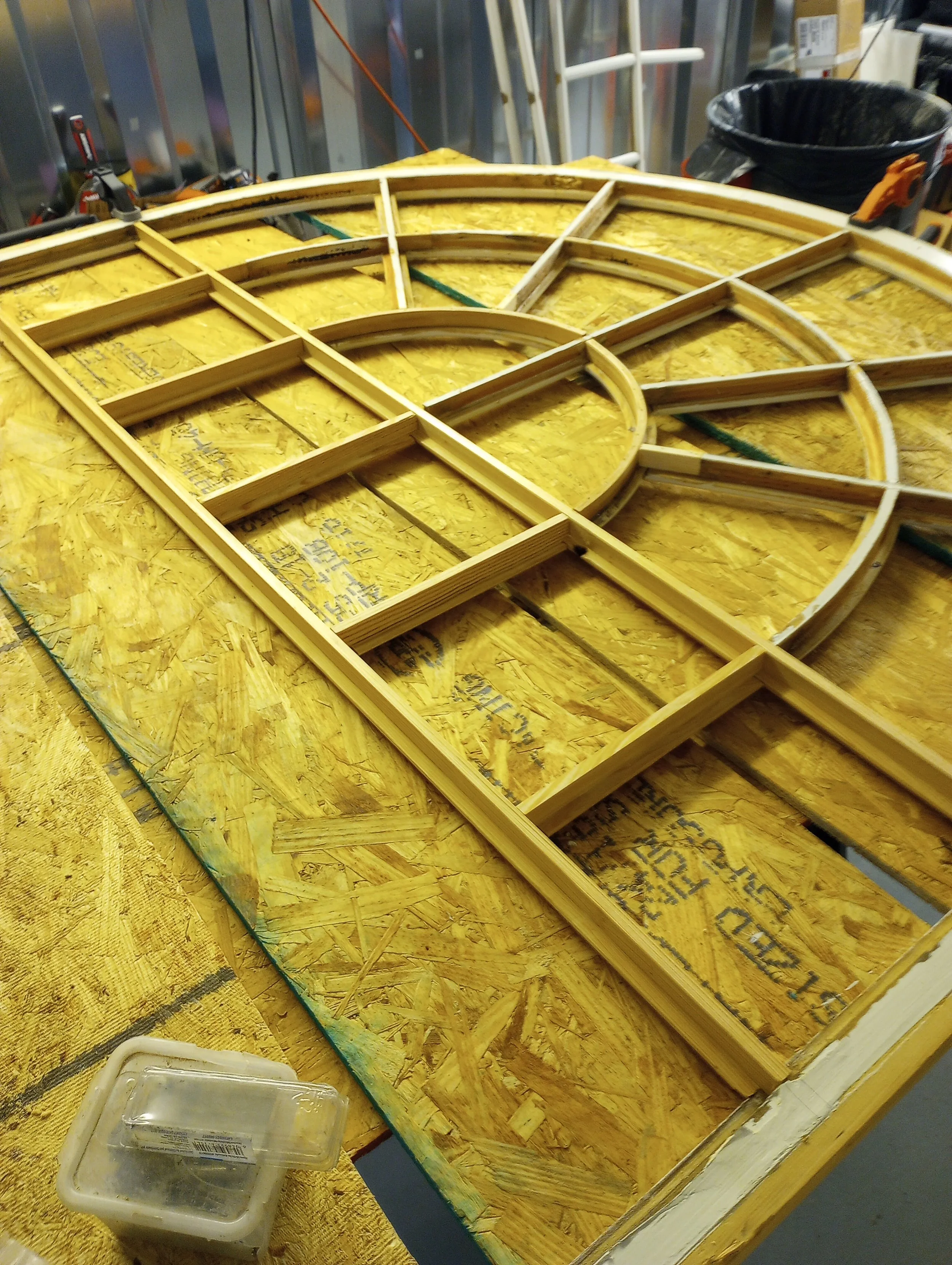 Wooden frame being assembled on a workbench in a workshop.