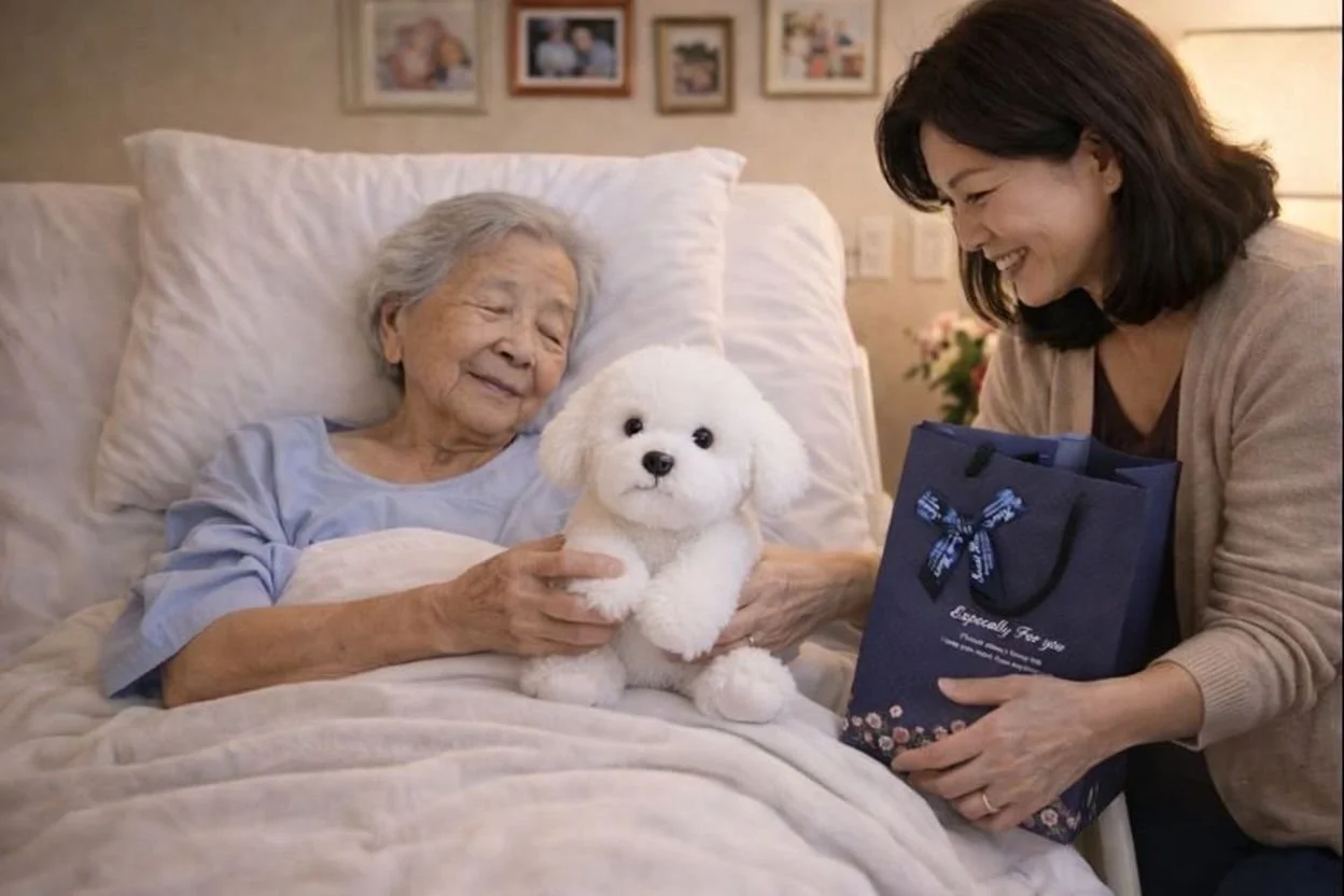 Hospice patient recieves lifelike plush Maltese dog from caregiver.
