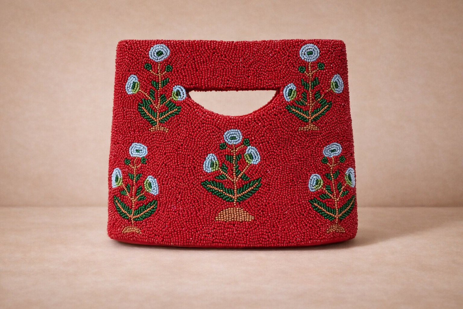 Red handbag with beaded floral embroidery pattern.