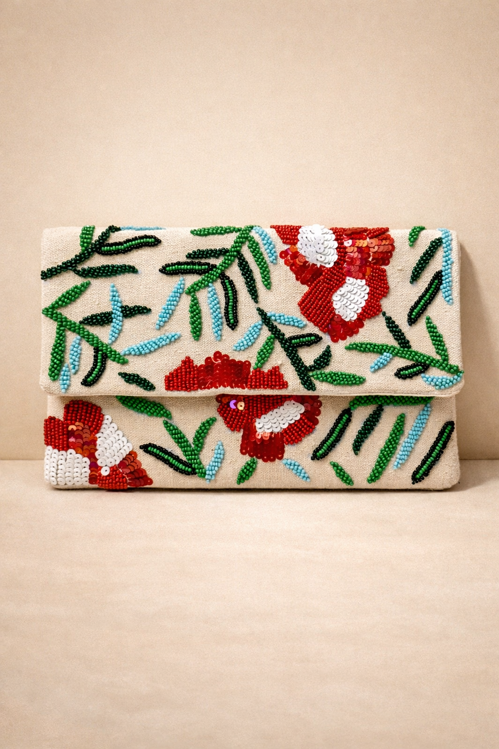 A beige clutch purse decorated with colorful beaded embroidery of red and white flowers and green and blue leaves.