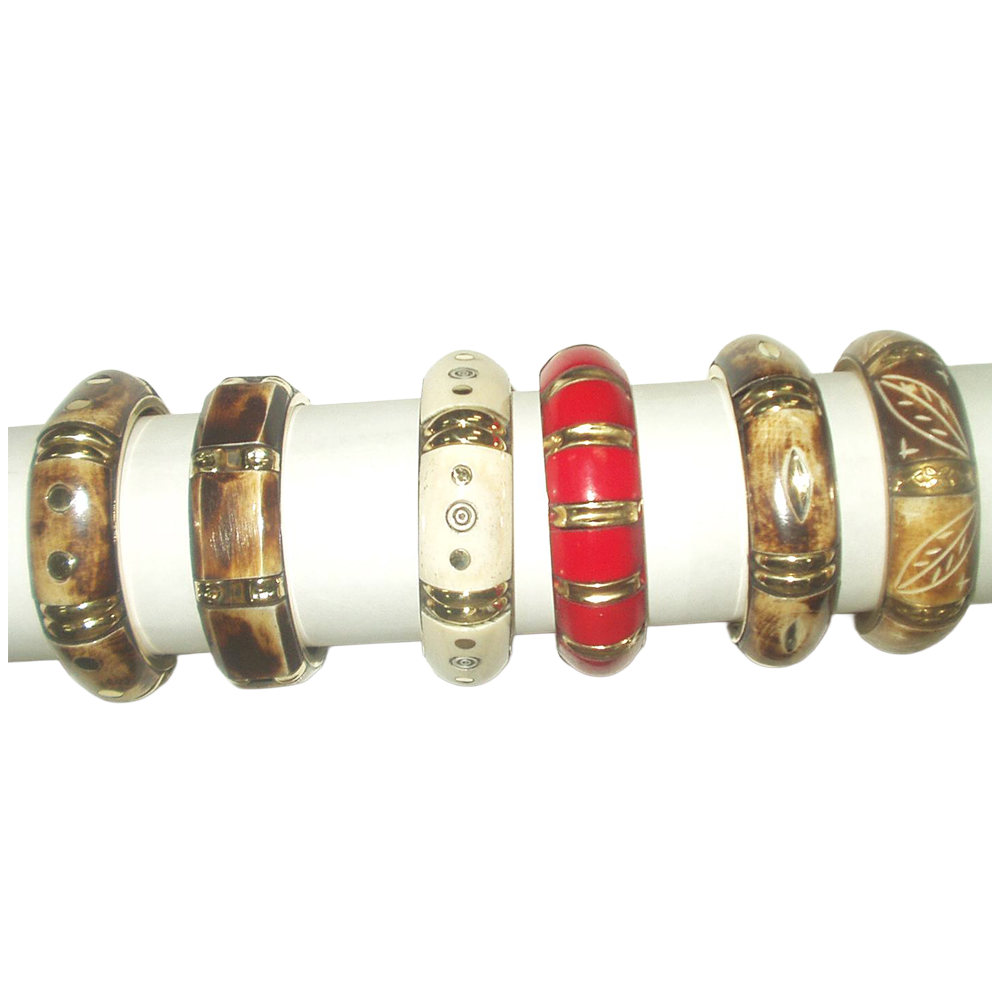 A collection of seven bangle bracelets displayed on a white cylindrical stand. The bangles are made of various materials, including wood, metal, and colored resin with designs and patterns.
