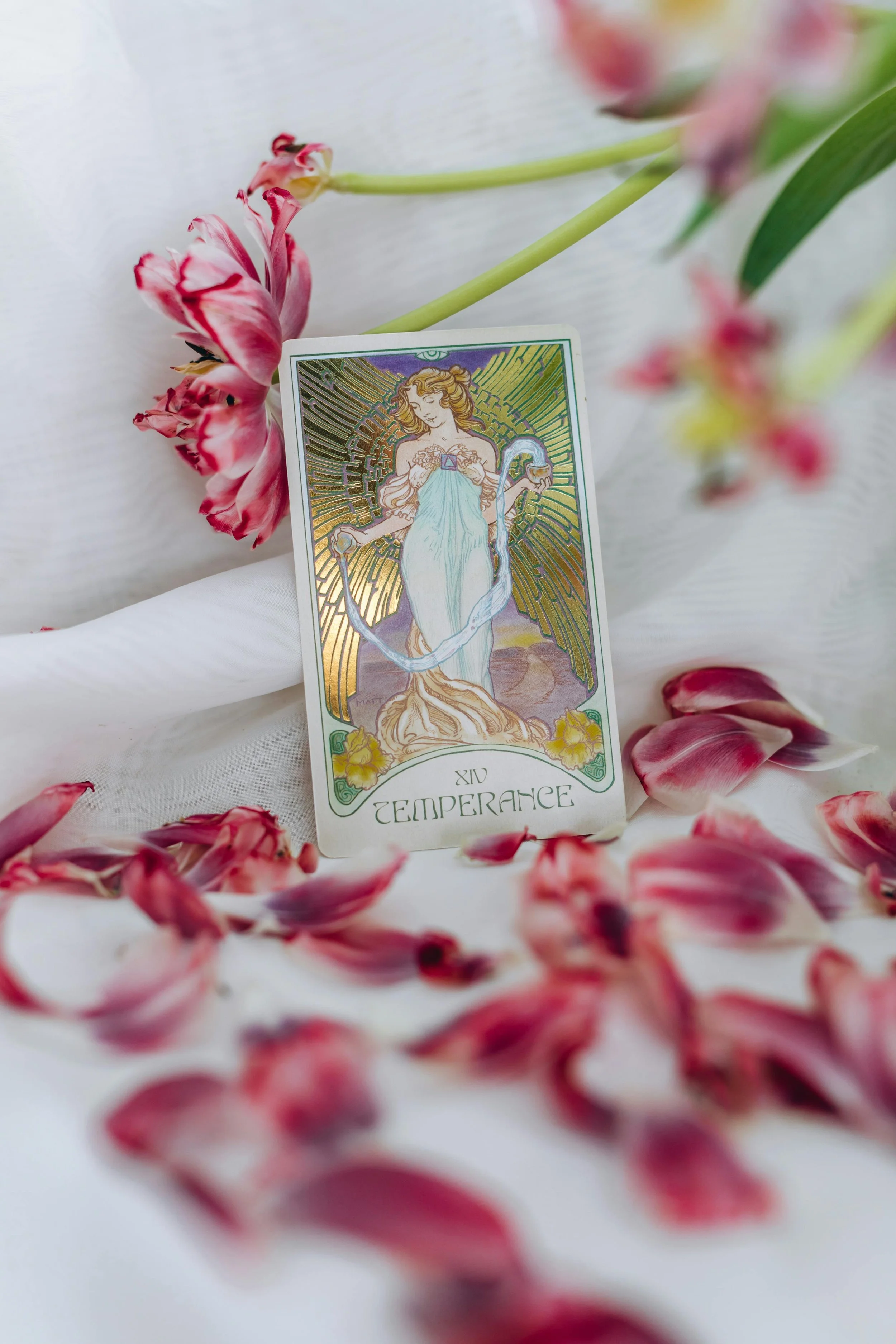 Temperance tarot card on white linen with pink flowers