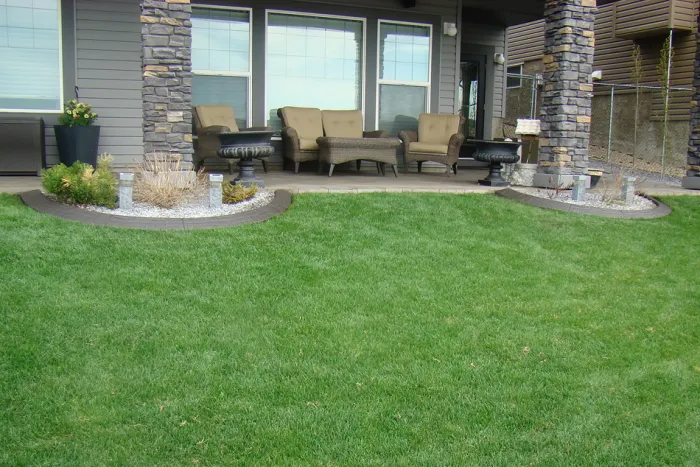 Decorative offset bond concrete curbing by Creative Edge in yard with low-maintenance finish