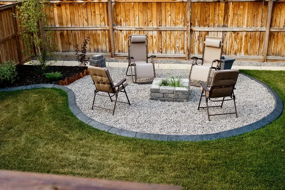Custom concrete borders backyard fire pit in Calgary
