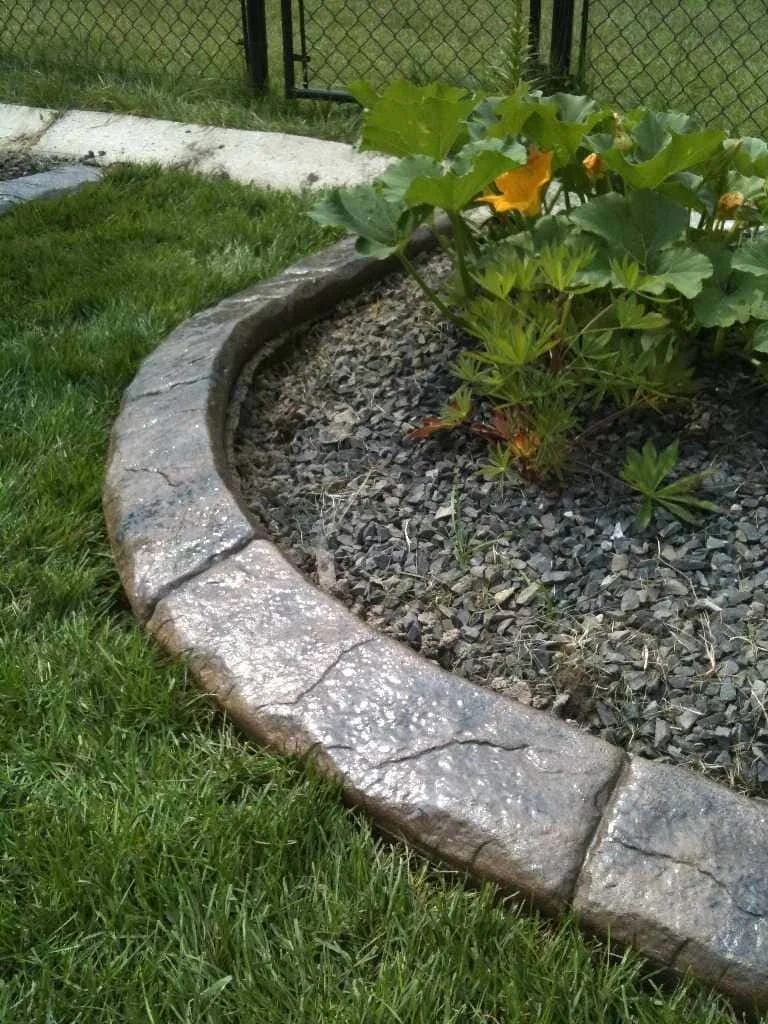 Natural stone style curbing creating smooth lawn transitions