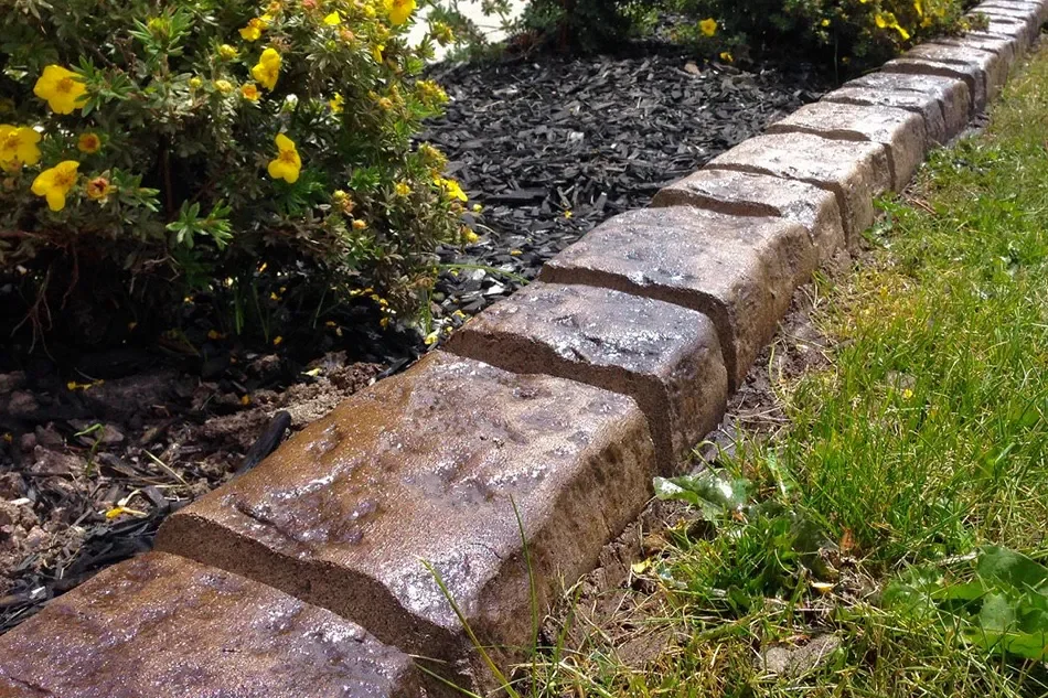 Belgian block style custom concrete curbing installed by Creative Edge Curbing in Strathmore