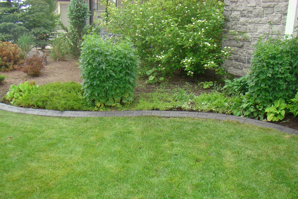 Durable concrete curbing installed around flower bed borders
