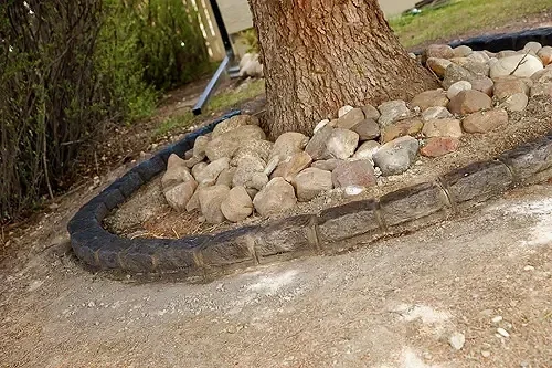 Belgian block concrete curbing with textured finish along landscaped garden edge