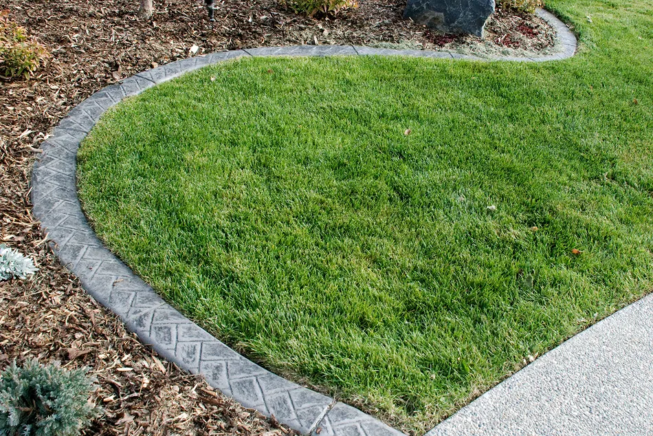 Herringbone textured concrete curbing with custom profile in High River