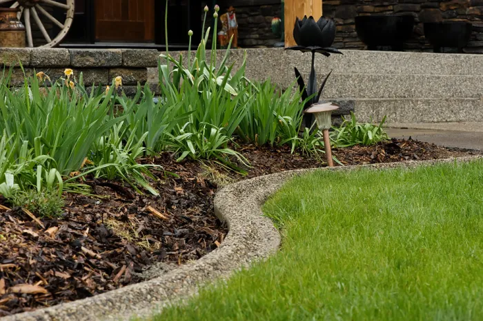 Beautiful custom curbing in Exposed Aggregate surrounding garden near front steps