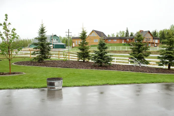 Exposed aggregate concrete curbing featured along driveway
