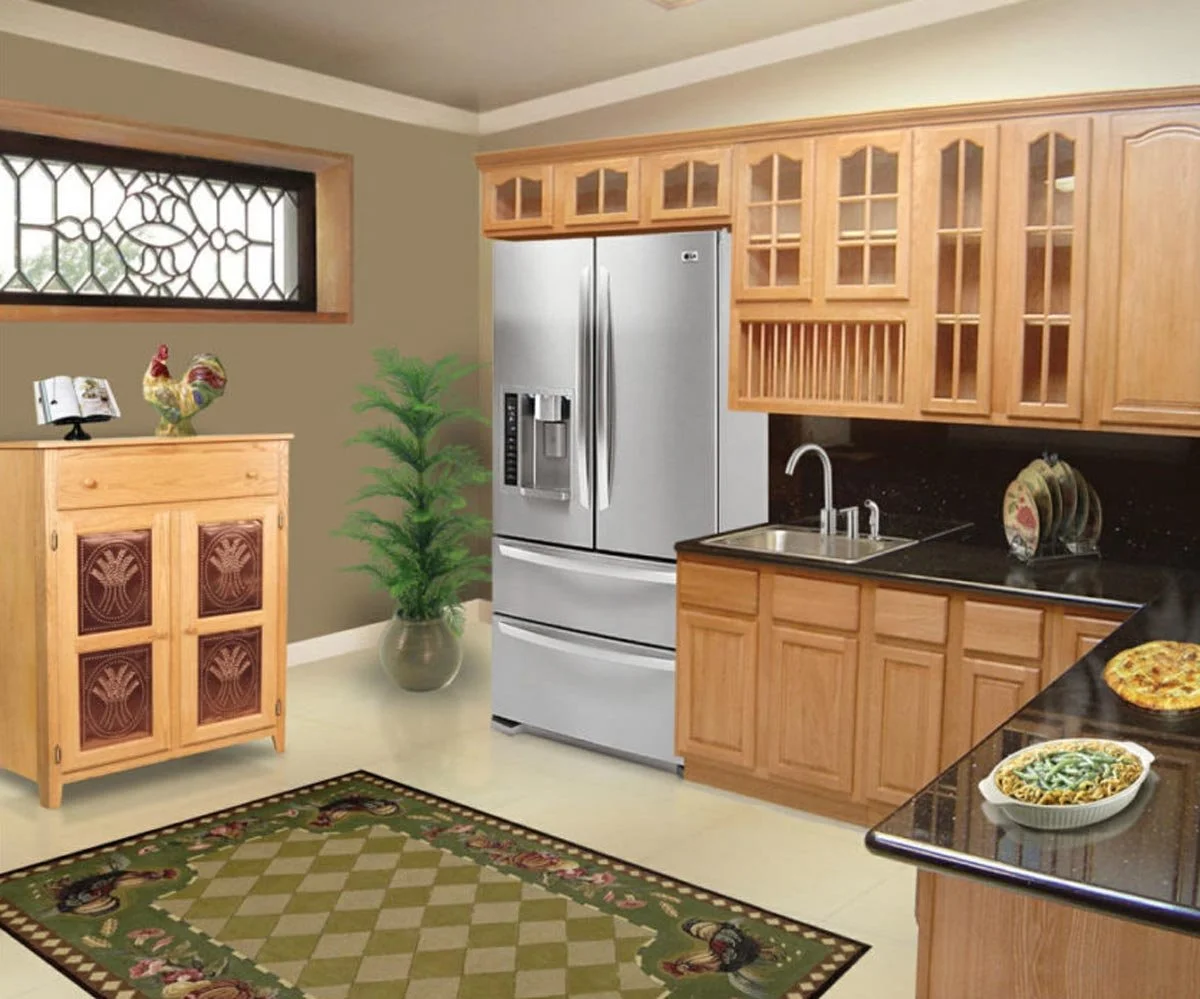 A kitchen with wooden cabinets, a stainless steel refrigerator, a small wooden cabinet with decorative panels, a potted plant, and a kitchen counter with dishes. There is a window with decorative glass and a rug with roosters.