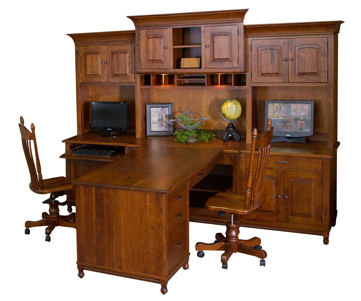 A large wooden home office desk with two chairs, a hutch, and shelves, including computers, a globe, and decorative items.