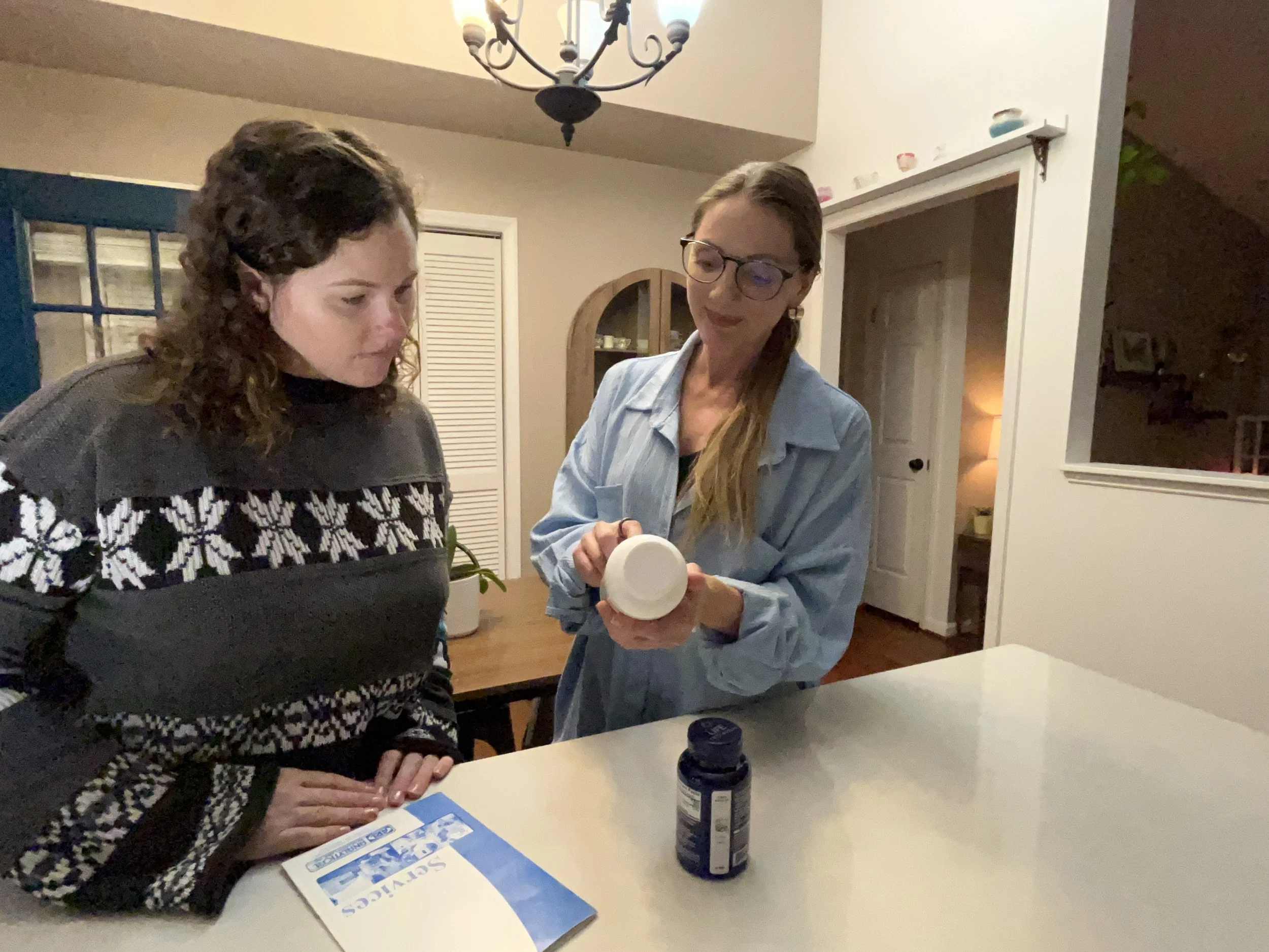 Women reviewing supplements with patient